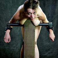 Nadia White is bound with tits exposed and mouth spread wide
