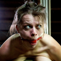 Nadia White is bound with tits exposed and mouth spread wide