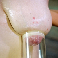 Nadia White is bound with tits exposed and mouth spread wide