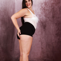 Curvy brunette girl Dria Submits strips naked flashing her bushy snatch