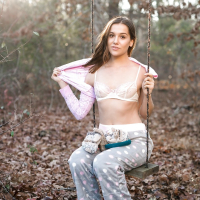 Solo girl Kasey Warner undressing for nude shoot outdoors in woods clearing