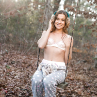 Solo girl Kasey Warner undressing for nude shoot outdoors in woods clearing