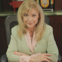 Blonde mature babe Nina Hartley is showing her big tits in stockings
