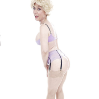 Experienced pornstar Nina Hartley posing topless in sexy lingerie