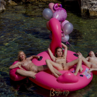 Cute chick Milena has fun with three friends on a pink flamingo