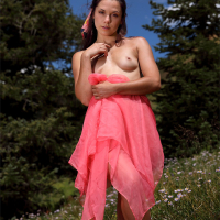 Pretty brunette babe Elena Generi showing her hairy pussy outdoors