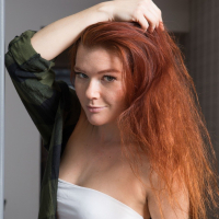 Redhead Mia Sollis posing sexy and getting naked