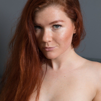 Redhead Mia Sollis posing sexy and getting naked