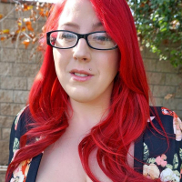 Redhead Bimbo Kamille Amora exposes her huge Tits