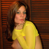 Super cute Katie teases with her big tits in a very bright yellow fishnet top