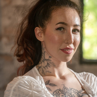 Tattooed redhead chick Esluna Love bends over for deep doggy style sex