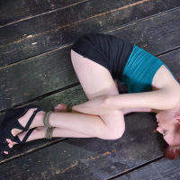 Ashley Lane redhead rope bound with tits exposed and ass toyed