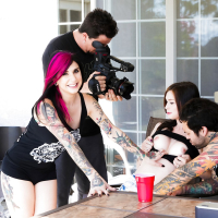 Tattooed dark haired slut in short skirt gives hot handjob during threesome