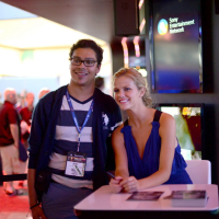 Brooklyn Decker showing big cleavage in blue mini dress at PlayStation booth at