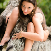 Julie Skyhigh wearing a leather Suit and GString