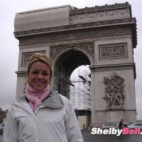 Cheerful blonde Shelby Bell posing in the streets of Paris