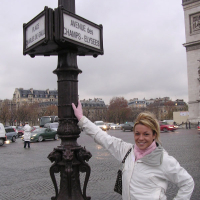 Cheerful blonde Shelby Bell posing in the streets of Paris