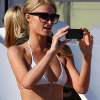 Paris Hilton showing her hard pokies in white transparent bikini top on the beac