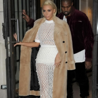 Kim Kardashian in a white mesh dress leaving her hotel in Paris