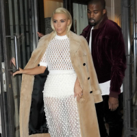 Kim Kardashian in a white mesh dress leaving her hotel in Paris