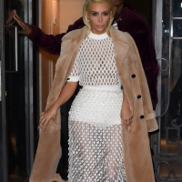 Kim Kardashian in a white mesh dress leaving her hotel in Paris