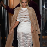Kim Kardashian in a white mesh dress leaving her hotel in Paris