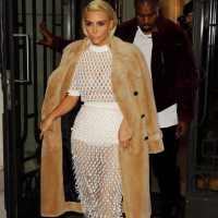 Kim Kardashian in a white mesh dress leaving her hotel in Paris
