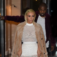 Kim Kardashian in a white mesh dress leaving her hotel in Paris