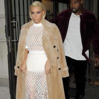 Kim Kardashian in a white mesh dress leaving her hotel in Paris