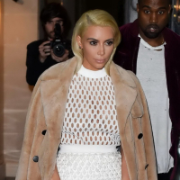 Kim Kardashian in a white mesh dress leaving her hotel in Paris
