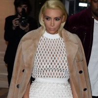 Kim Kardashian in a white mesh dress leaving her hotel in Paris