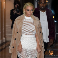 Kim Kardashian in a white mesh dress leaving her hotel in Paris