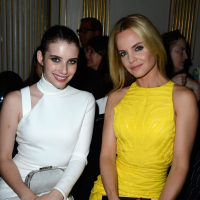 Emma Roberts wearing tight white mini dress with Mena Suvari at Versace show dur