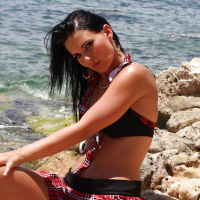 Pornstar babe Mili Jay strips off skirt and underwear for erotic posing