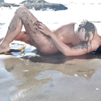 Chesty brunette pornstar Leanne Crow exposing huge hooters on the beach