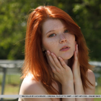 Natural redhead Mia Sollis outdoors in bare feet airing nude tits and pussy