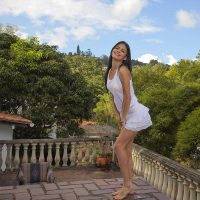 Beautiful latina Denise Gomez slowly strips out of her yellow bikini
