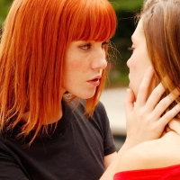 Adorable lesbian Kiera Winters making out with her friend outdoor