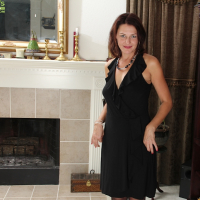 Milf babe Ava Austin is posing in her sexy black dress on camera