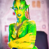 Kinky cosplay chick Tiffany Doll posing in body paint uniform and spreading