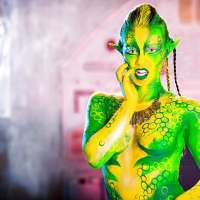 Kinky cosplay chick Tiffany Doll posing in body paint uniform and spreading