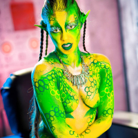 Kinky cosplay chick Tiffany Doll posing in body paint uniform and spreading