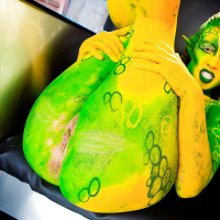 Kinky cosplay chick Tiffany Doll posing in body paint uniform and spreading