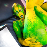 Kinky cosplay chick Tiffany Doll posing in body paint uniform and spreading