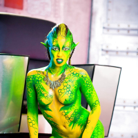 Kinky cosplay chick Tiffany Doll posing in body paint uniform and spreading