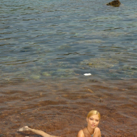Seductive blonde Adriana Malkova poses on the beach