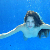 Beautiful girl Talia Mint gets naked by the pool in Zismie