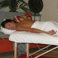 Brunette girl Amia Miley peeling off shorts before climbing aboard massage bed