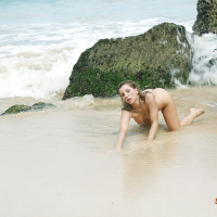 Blonde beach babe Ashley Fires modeling topless in bikini bottoms