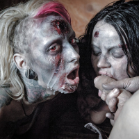 Fetish models Brittany Lynn and Jessie Lee giving head in Zombie threesome